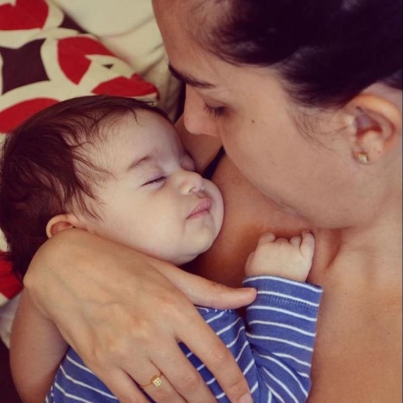 Patrícia Teixeira abraçando a filha Clarice, que dorme no colo